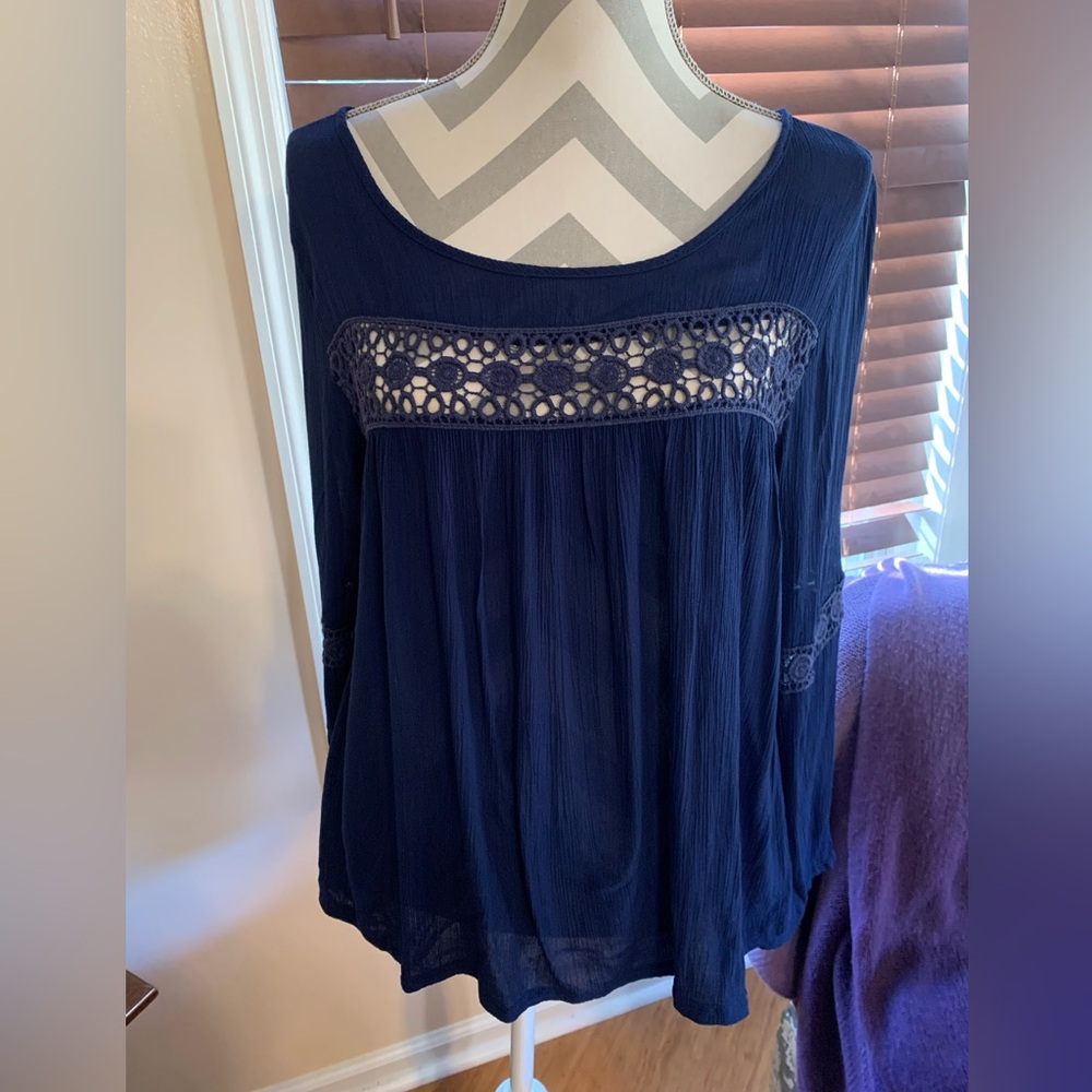 Astoria Born navy crepe blouse with flair sleeves.